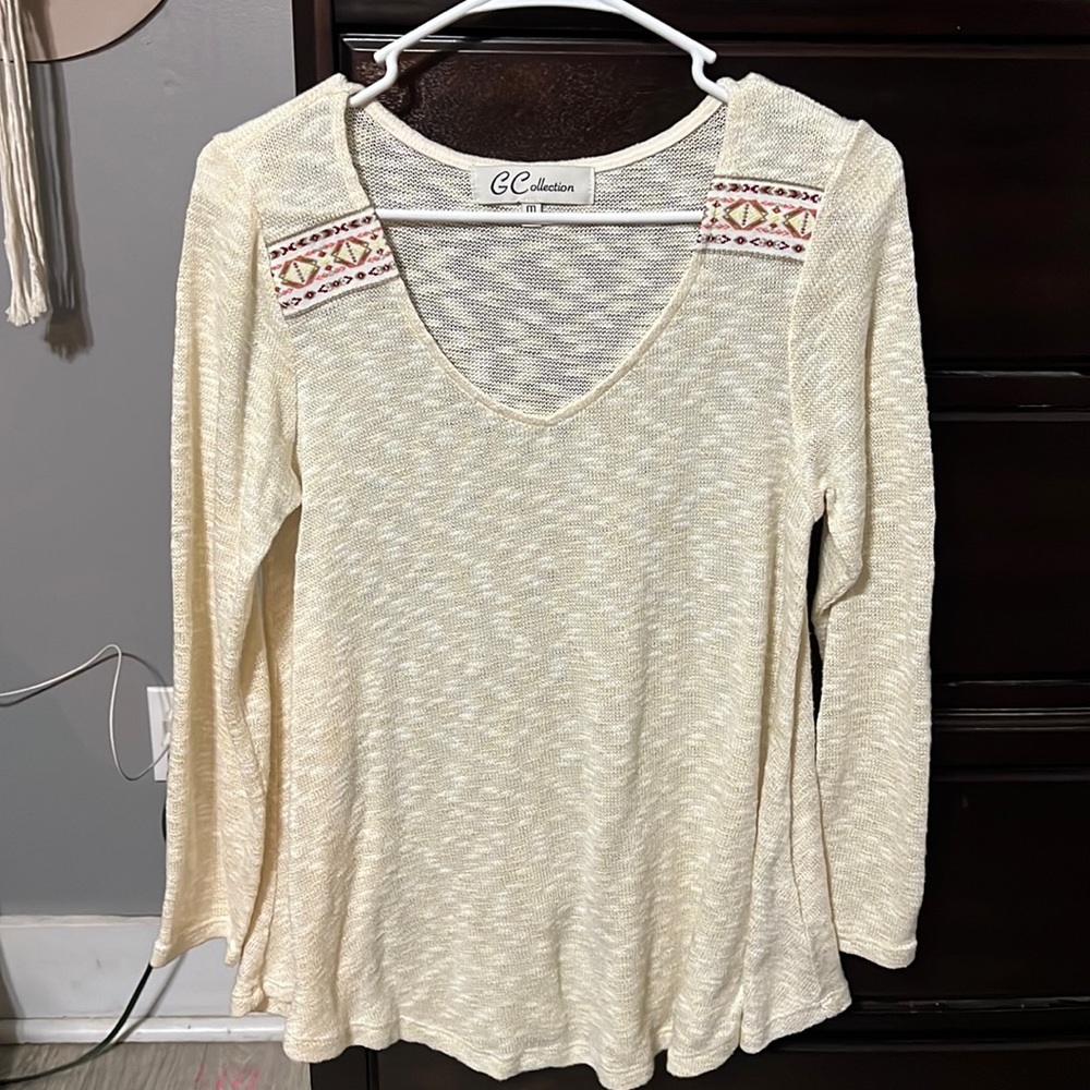 Green sweater with tribal detailing